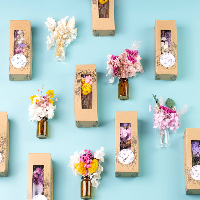 Mini bouquets of dried flowers in delicate glass vase.