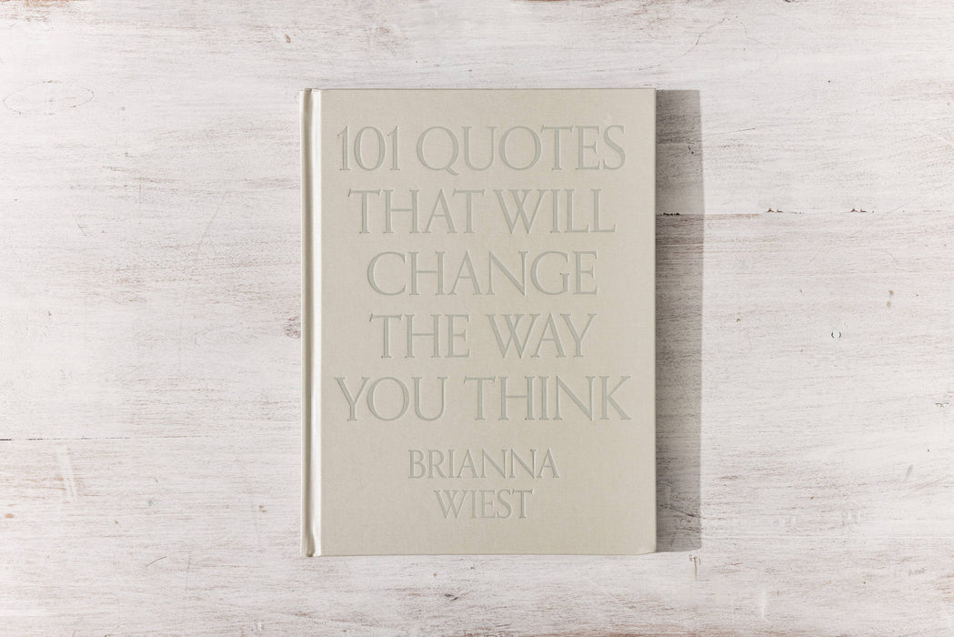 A hardcover coffee table book with a beige linen cover and gloss pigment foil, featuring 101 quotes by Brianna Wiest that will change the way you think.