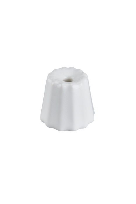 Small candle holder in the shape of a traditional French dessert canelé in a matte white finish.