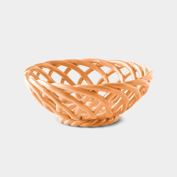 A small, pink ceramic basket with a geometric pattern and a glossy finish.