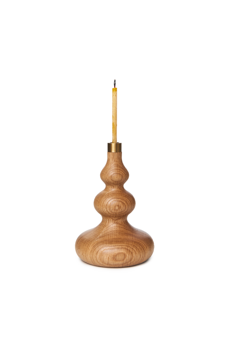 Oiled oak candle stick holder with brass detail and slim beeswax candle.