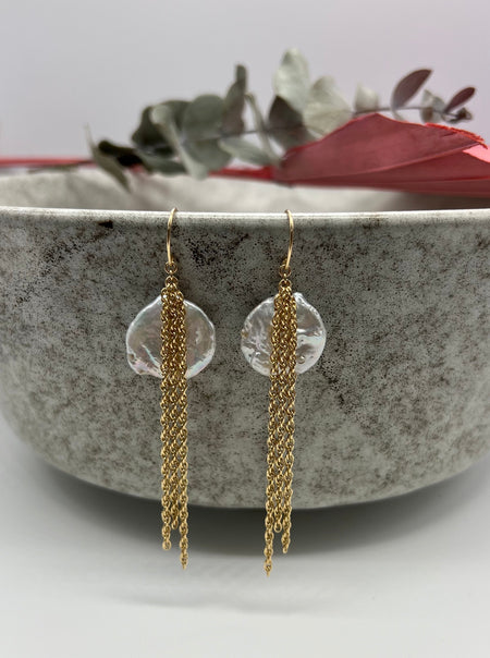 Image shows Ava Earrings. Each adorned with three 1.5" 14k gold filled rope chains and a white freshwater coin pearl.