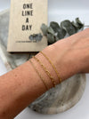 Paperclip, Figaro, and Rope Chain permanent 14k gold-filled bracelets on wrist.
