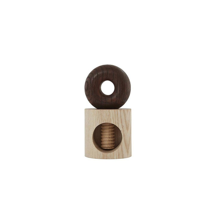 Wooden toy with a round donut-shaped top and square base on a white background