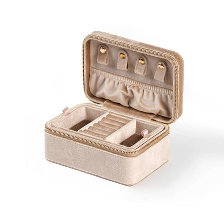 A small purple plush velvet jewelry box with a gold buckle, open, showing compartments for storing jewelry like necklaces, rings, and earrings.