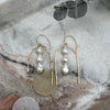 Drop earrings with 14-K gold-filled hammered finish coupled with the distinctively shaped off-white freshwater pearls.