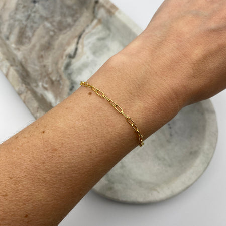 14-K gold-filled paperclip bracelet on wrist.