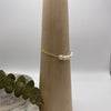 14k gold-filled chain bracelet adorned by six freshwater pearls showcased over wooden bracelet holder cone.