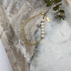 14k gold-filled chain bracelet adorned by six off-white freshwater pearls farm raised in the US.