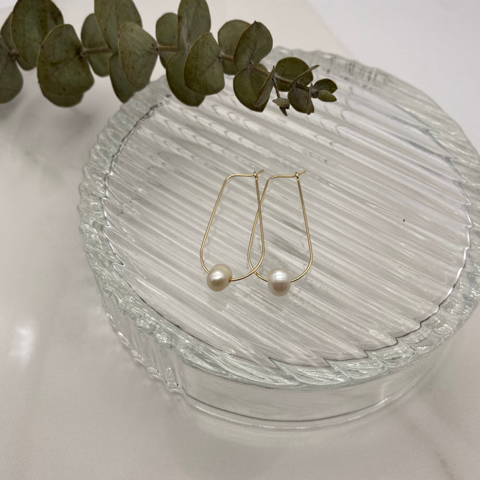 14-k gold-filled drop earring adorned with off-white freshwater pearl.