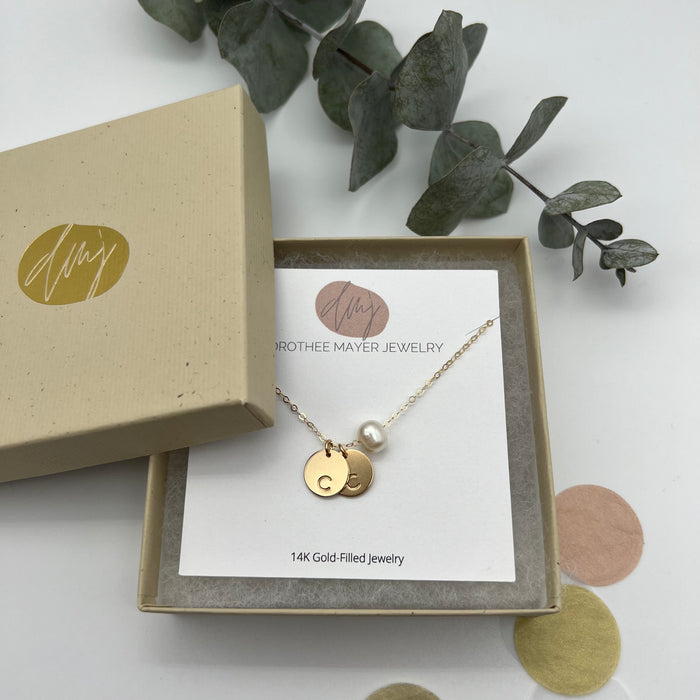 Personalized gold necklace with two initialed gold coins.