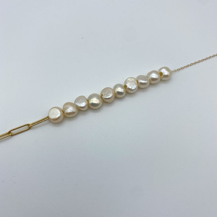 Close up of the ten off-white pearls on the Emma Necklace.